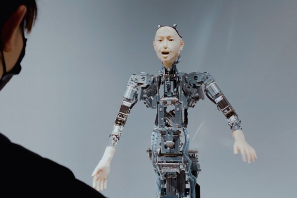 Conceptual digital art of a humanoid robot looking into a mirror and seeing different national flags and political symbols, illustrating the myth of AI neutrality and geopolitical mirroring.